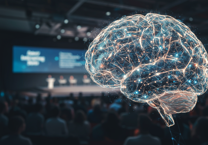 Close-up, imagem altamente detalhada de um cérebro futurista de IA com redes neurais brilhantes. Ao fundo, sutilmente desfocado, um palco de conferência moderno com uma audiência. O foco central é o cérebro de IA, simbolizando a inovação em inteligência artificial em um grande evento de tecnologia.